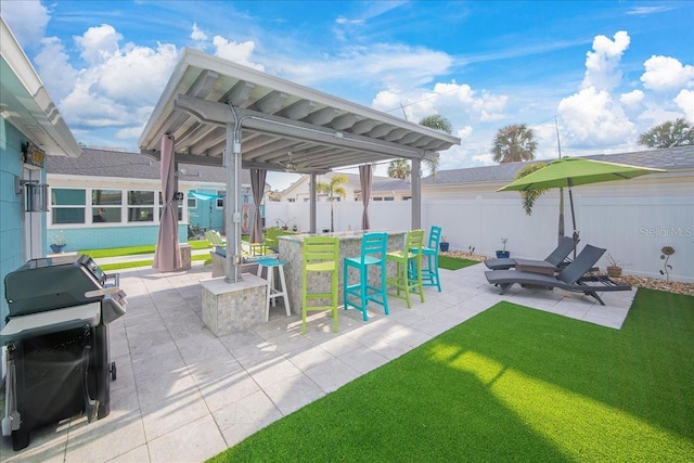 view of patio / terrace featuring exterior bar and a grill