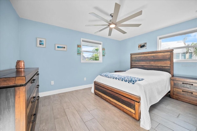 bedroom with light hardwood / wood-style flooring and ceiling fan