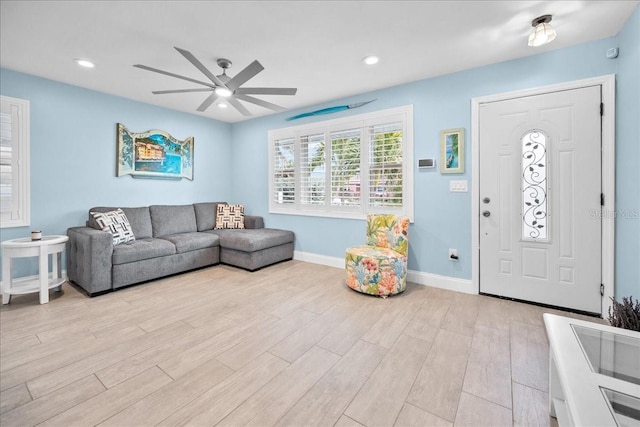 living room with ceiling fan and light hardwood / wood-style flooring