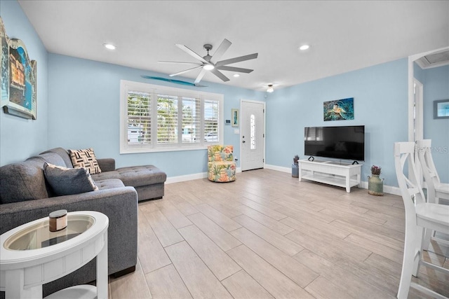 living room featuring ceiling fan and light hardwood / wood-style flooring