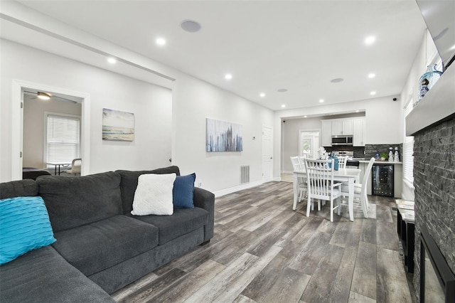 living room with dark hardwood / wood-style flooring and a fireplace