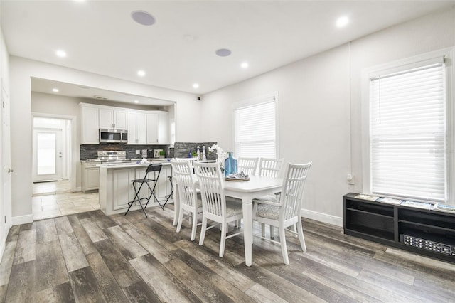 dining space with hardwood / wood-style flooring and a wealth of natural light