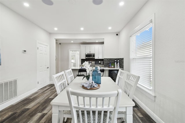 dining area featuring dark wood-type flooring