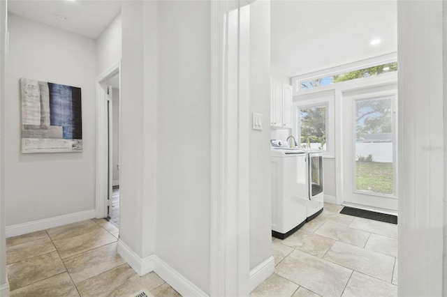 laundry room featuring light tile patterned flooring and separate washer and dryer