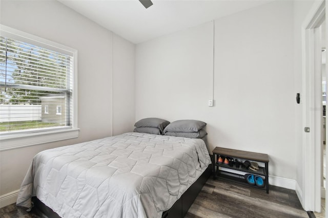 bedroom featuring multiple windows, hardwood / wood-style flooring, and ceiling fan