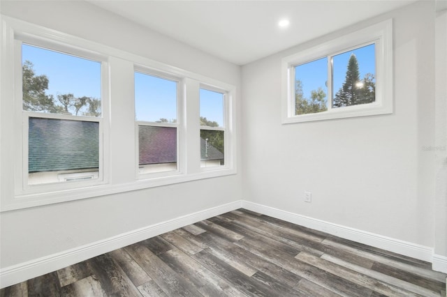 unfurnished room featuring dark hardwood / wood-style flooring