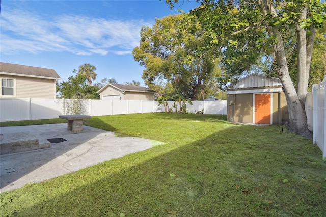 view of yard featuring a patio and a storage unit