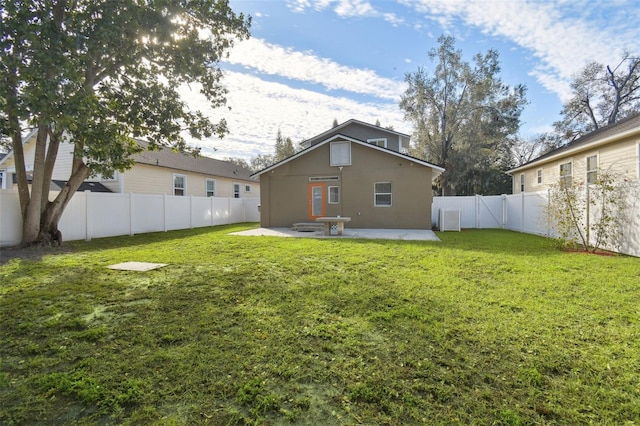 rear view of house with a yard and a patio area