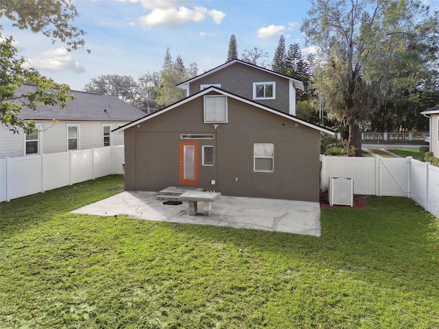 rear view of house with a yard and a patio area