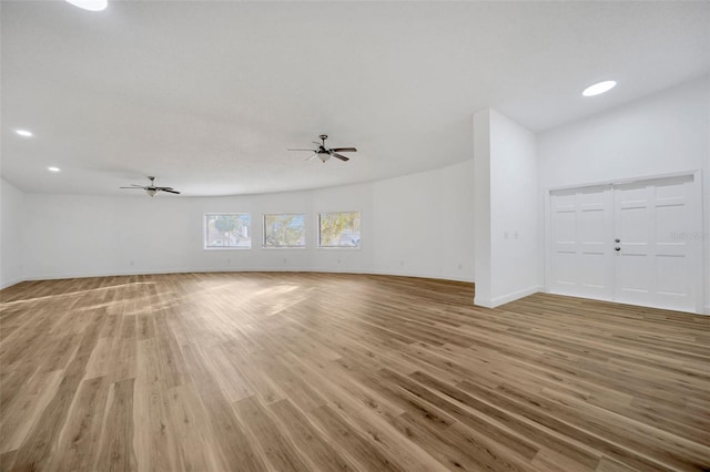 unfurnished living room with hardwood / wood-style flooring and ceiling fan