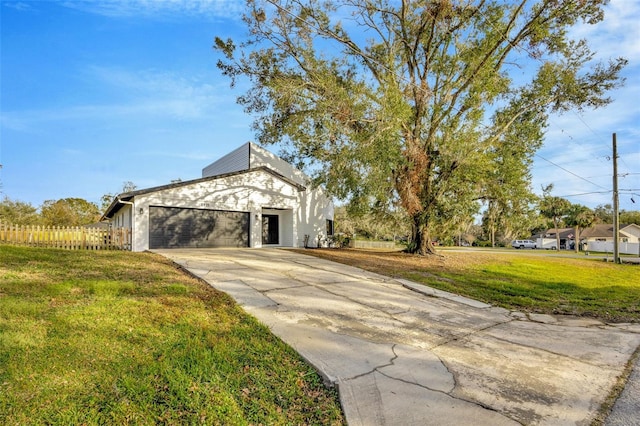 exterior space featuring a garage and a lawn