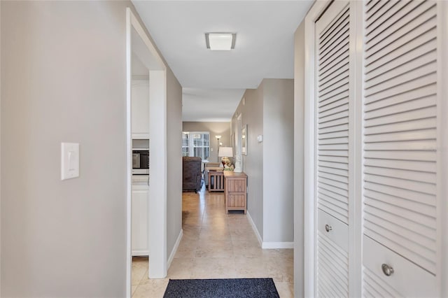 hall featuring light tile patterned floors