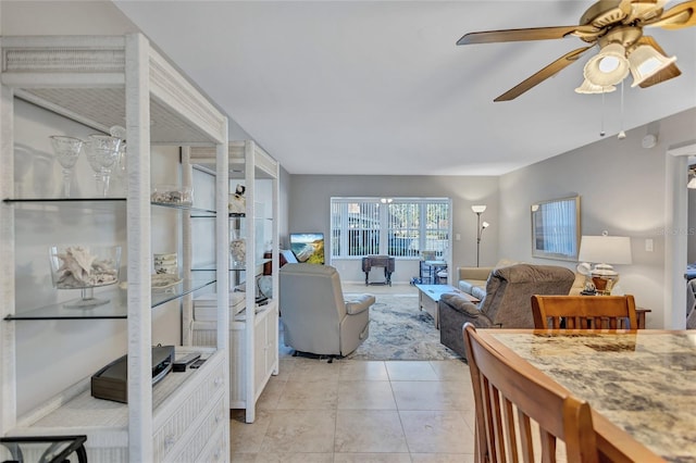 tiled living room with ceiling fan