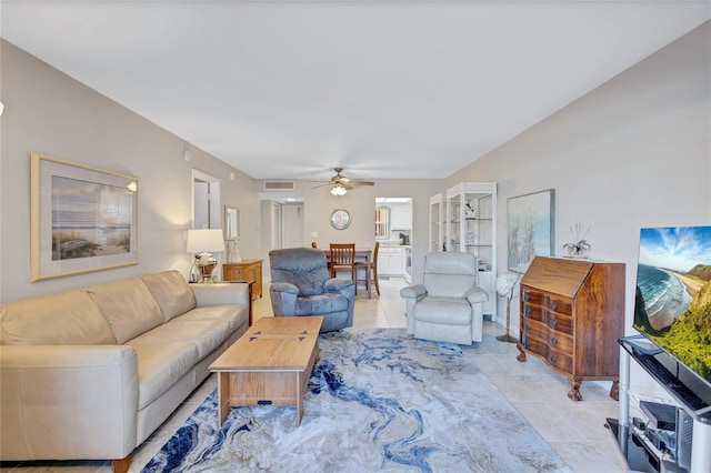 tiled living room with ceiling fan