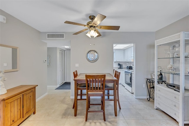 dining area with light tile patterned floors and ceiling fan