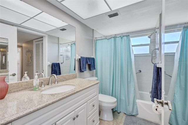 full bathroom featuring vanity, shower / tub combo, tile patterned floors, and toilet