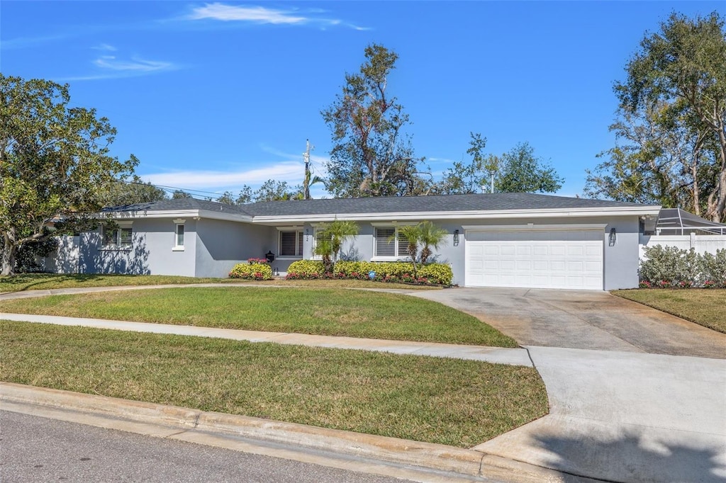 ranch-style home featuring a garage and a front yard