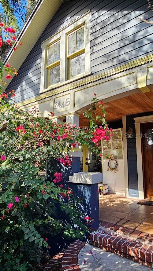 view of side of property with covered porch