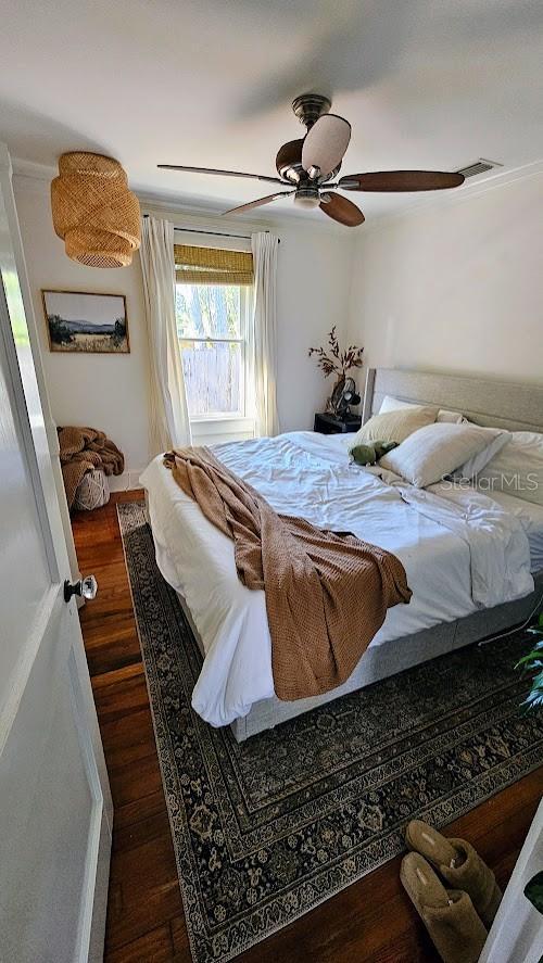 bedroom with dark wood-type flooring and ceiling fan