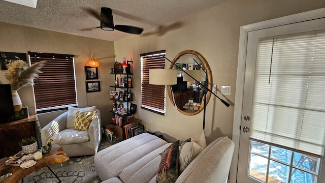 interior space featuring ceiling fan and a textured ceiling