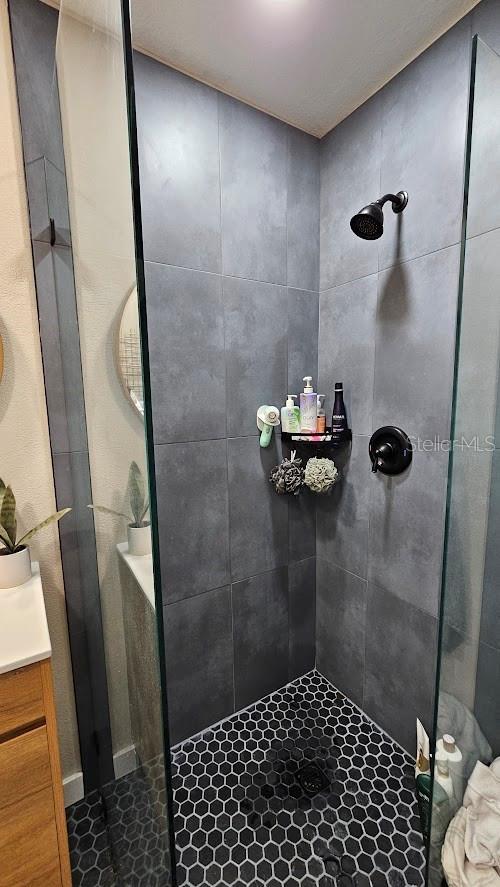 bathroom featuring vanity and a tile shower