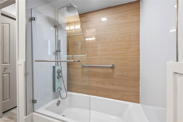 bathroom featuring combined bath / shower with glass door