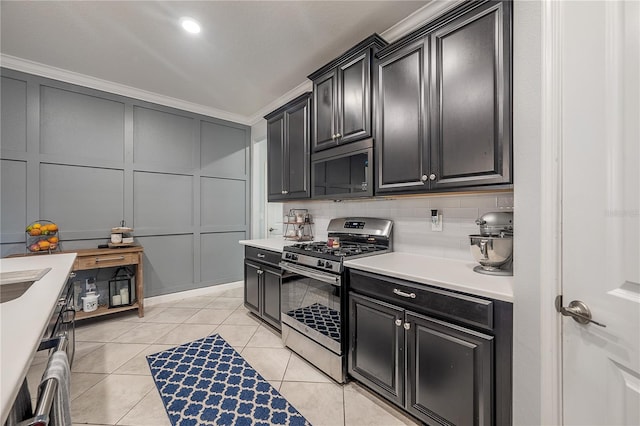 kitchen with light tile patterned flooring, ornamental molding, stainless steel appliances, and decorative backsplash