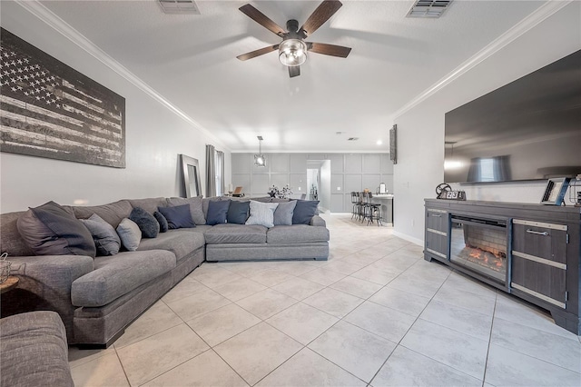 tiled living room featuring crown molding and ceiling fan