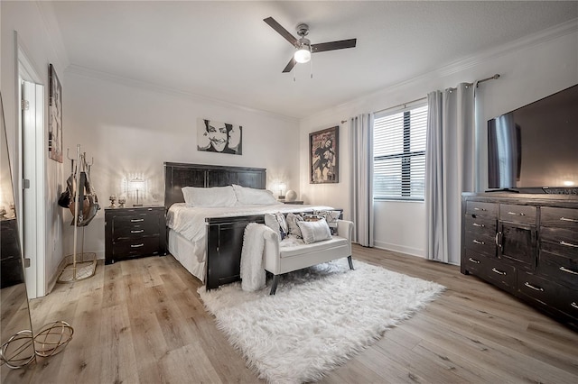 bedroom featuring crown molding, ceiling fan, and light hardwood / wood-style floors