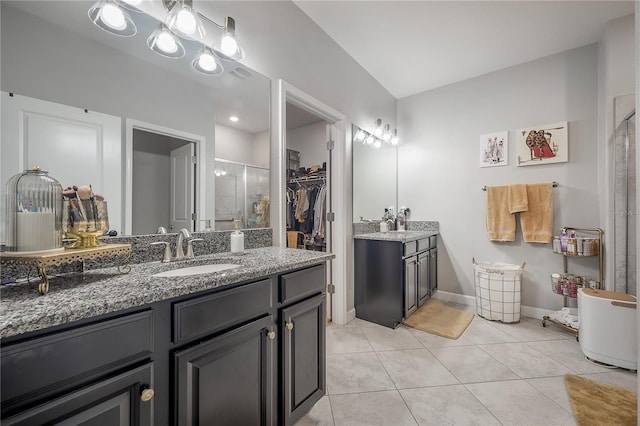 bathroom featuring vanity, tile patterned floors, and walk in shower