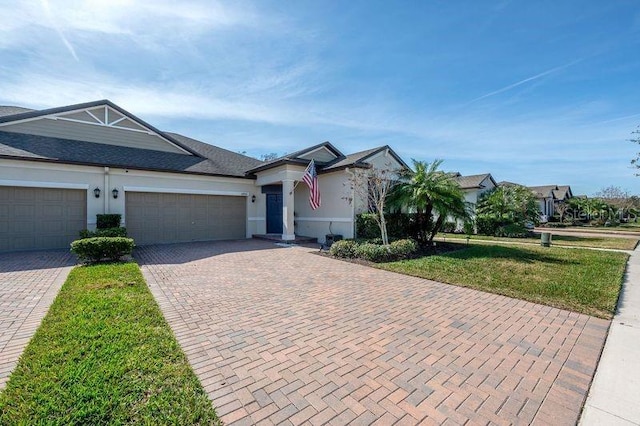 single story home featuring a garage and a front yard