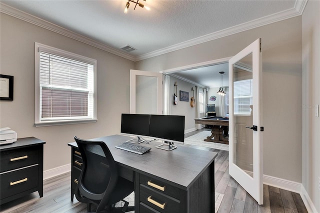 office area with crown molding, light hardwood / wood-style flooring, and a textured ceiling