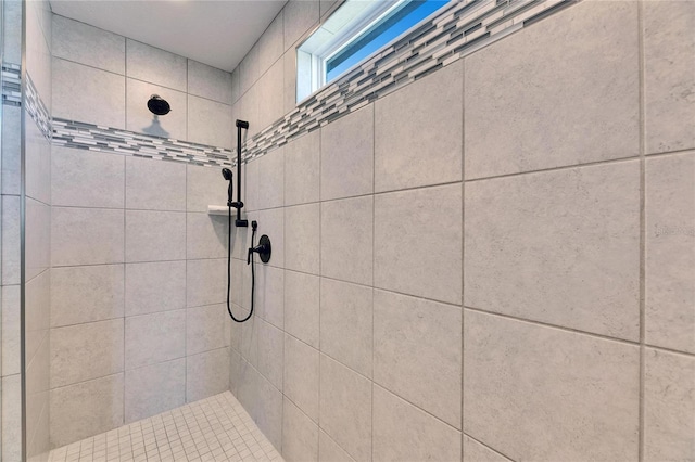 bathroom with tiled shower