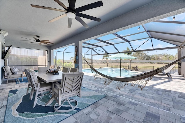 view of patio / terrace with ceiling fan and a lanai