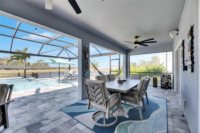 view of patio with a fenced in pool, a lanai, and ceiling fan