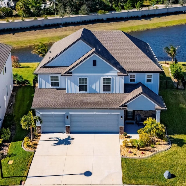 view of front of property featuring a water view and a garage