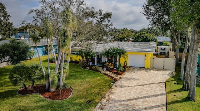 view of front of home with a garage and a front yard