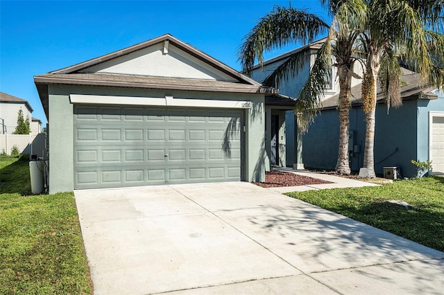 single story home featuring a garage and a front lawn