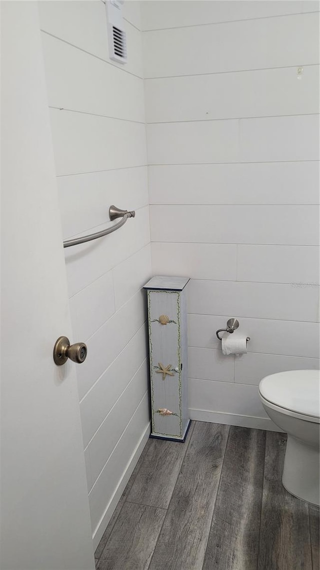 bathroom featuring wood-type flooring and toilet