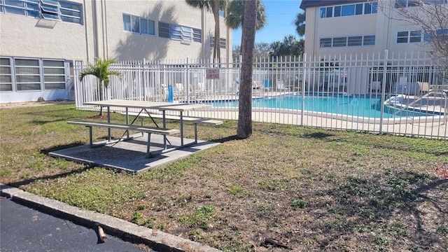 view of swimming pool with a yard and a patio