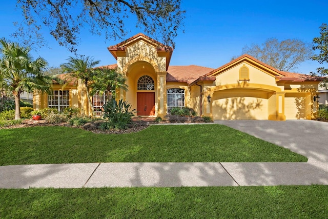 mediterranean / spanish-style house featuring a garage and a front yard