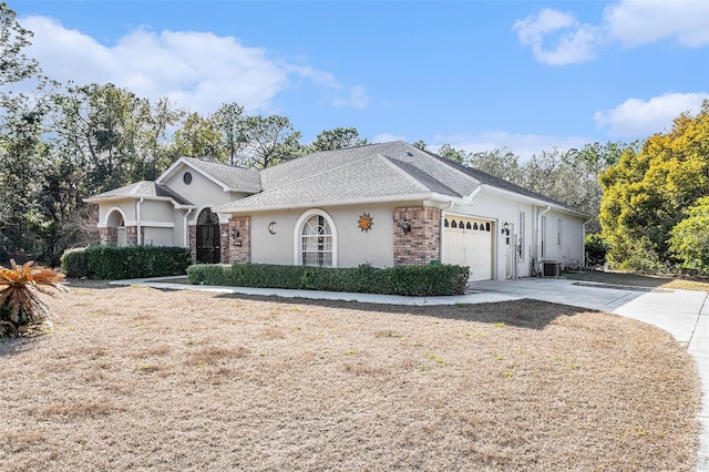 single story home featuring a garage and central AC unit