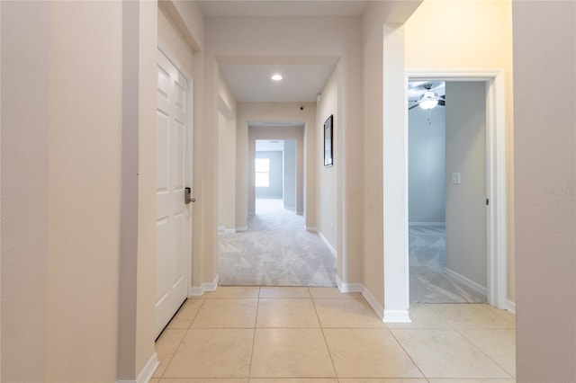 hallway with light colored carpet