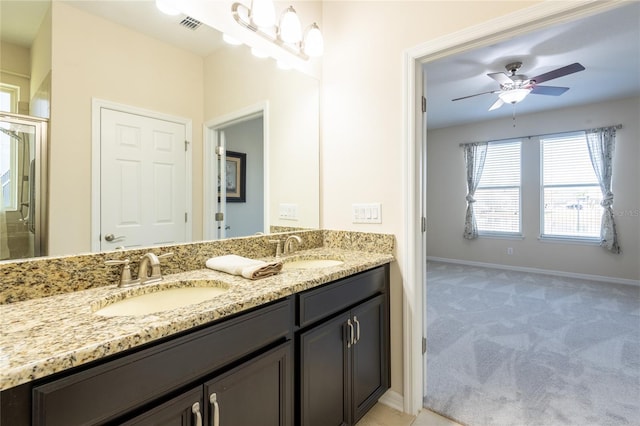 bathroom featuring vanity and ceiling fan with notable chandelier