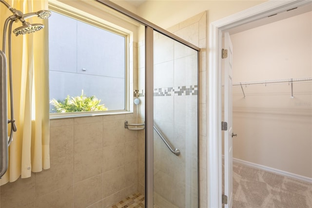 bathroom featuring a shower with door