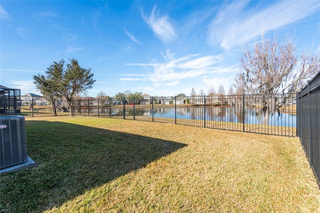 view of yard with a water view and central AC