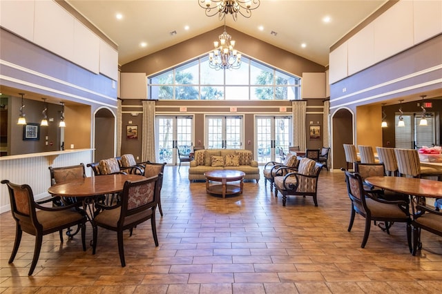 dining area featuring a towering ceiling and an inviting chandelier