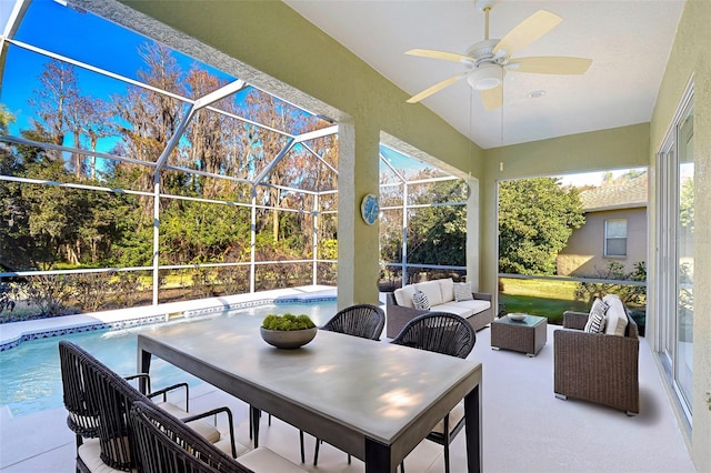 view of patio featuring a lanai, an outdoor hangout area, and ceiling fan