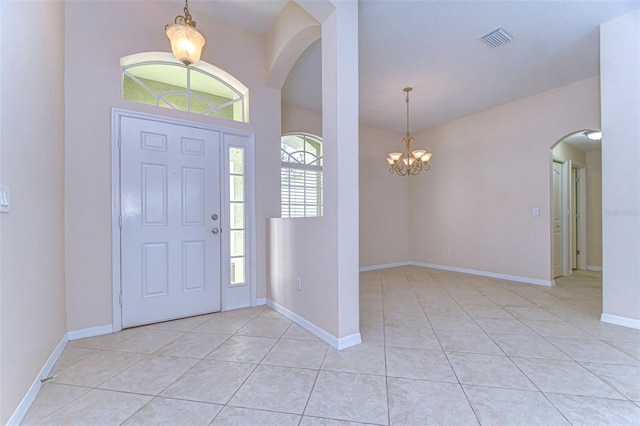 entryway featuring light tile patterned flooring and an inviting chandelier