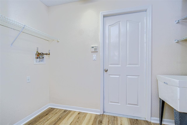 washroom featuring hardwood / wood-style flooring and washer hookup